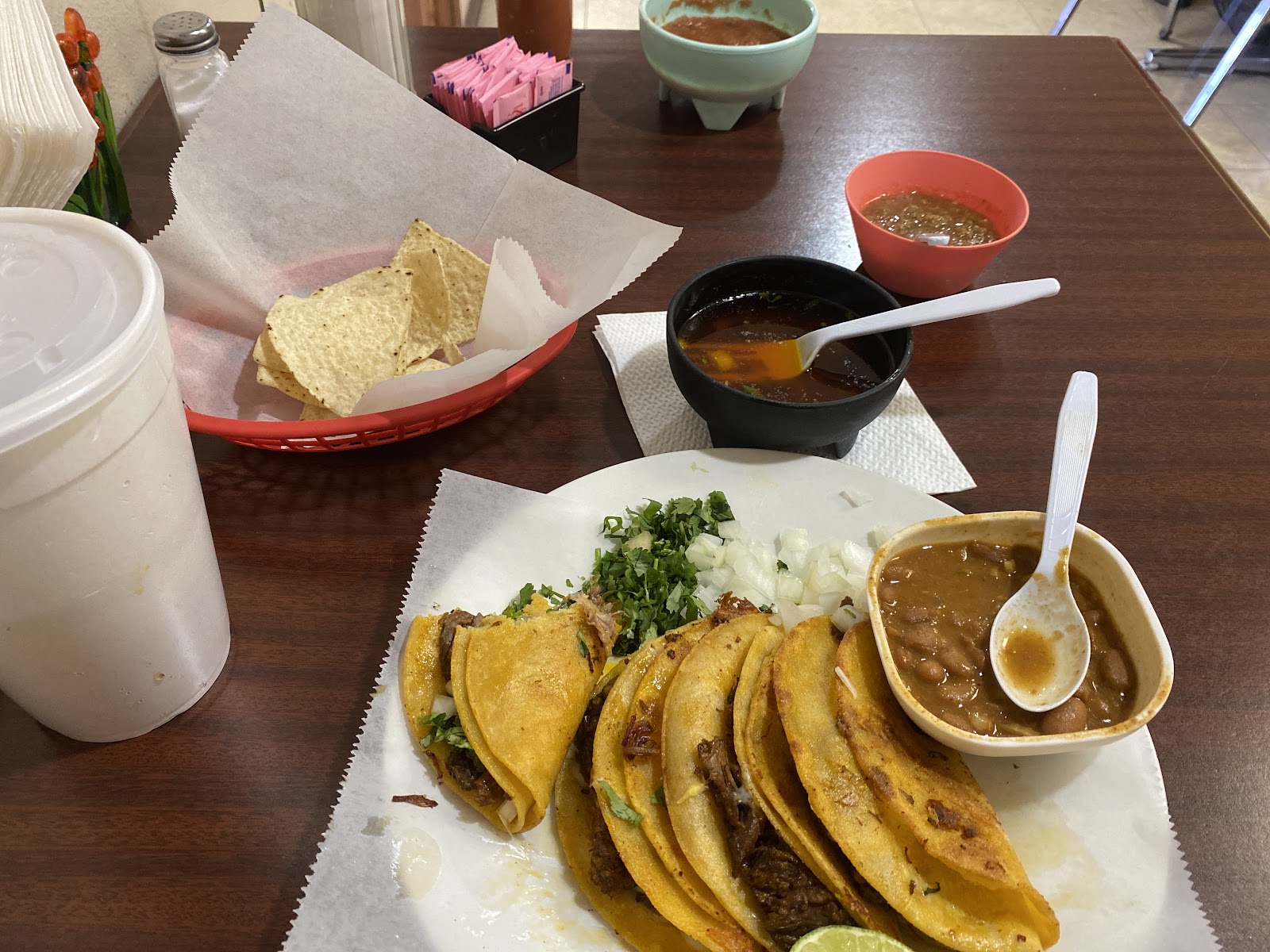 Crispy tacos served with beans, salsa and consomé