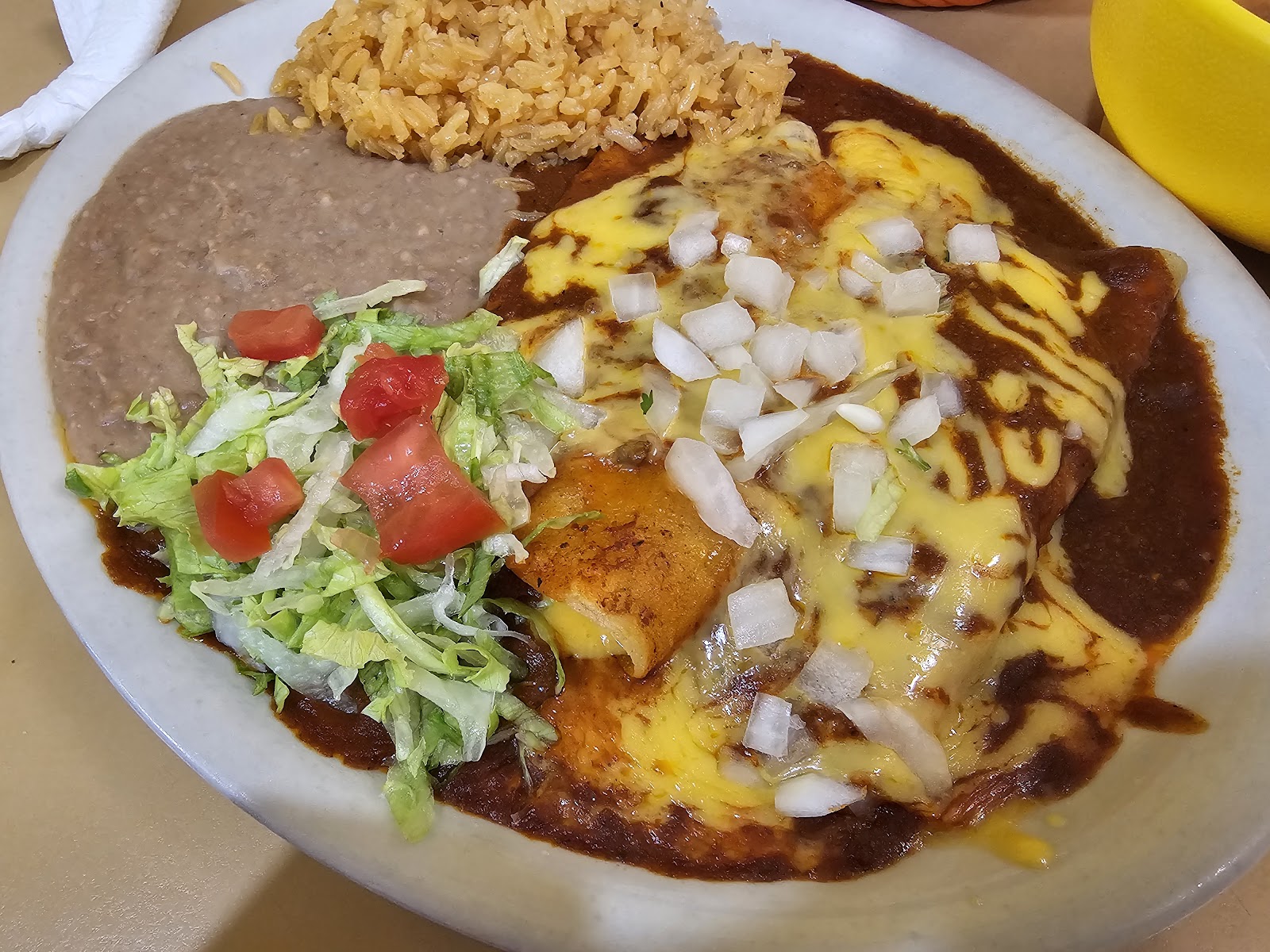 Cheese enchiladas plate with rice, beans and salad