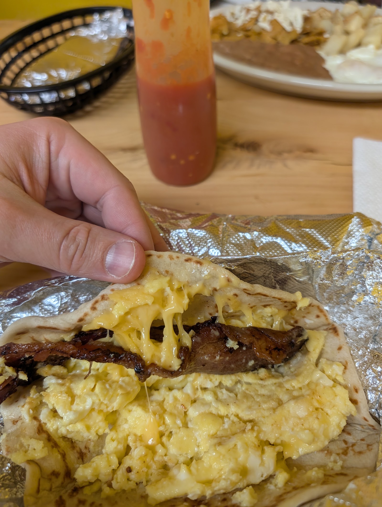 Bacon, egg and cheese taco on a griddled flour tortilla
