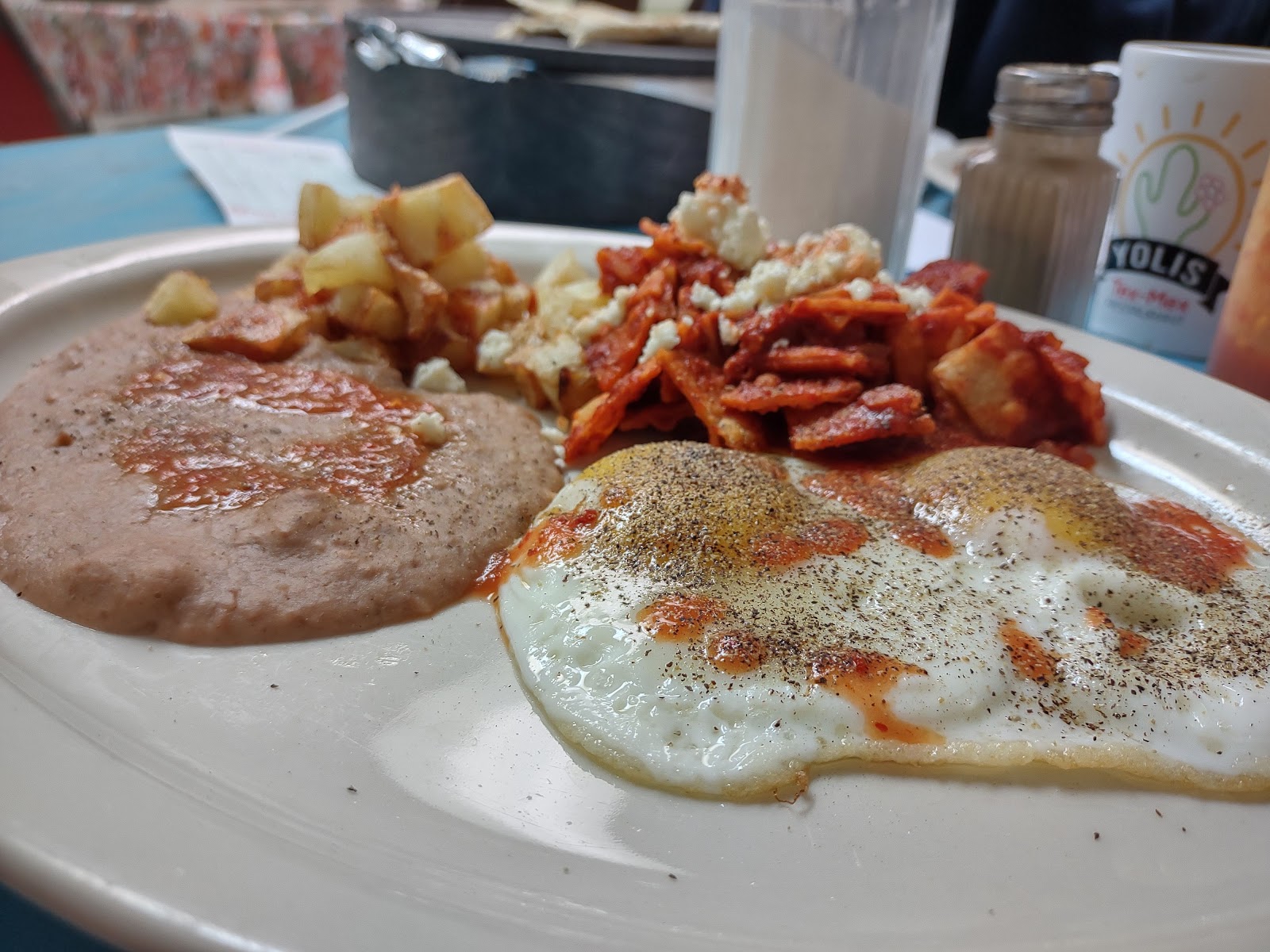 Breakfast plate with egg, chorizo and potatoes at Yoli's