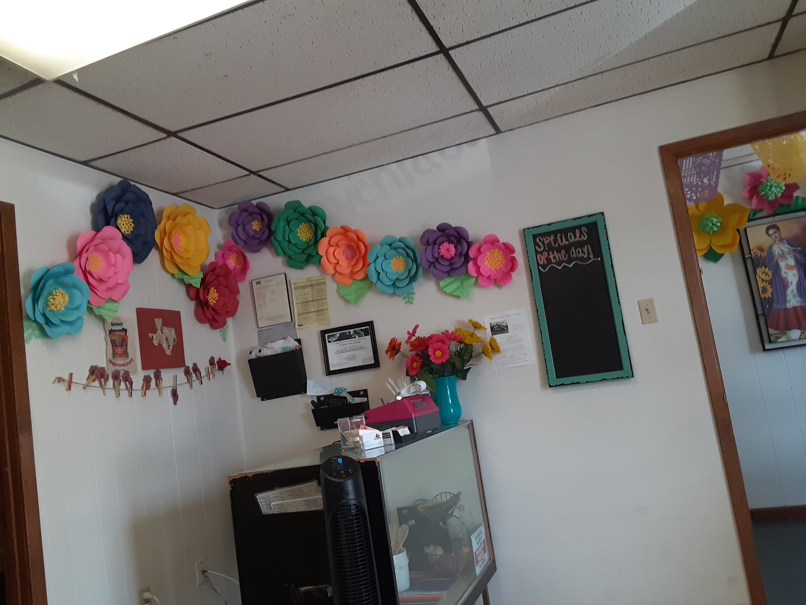 Colorful paper flower decorations inside Yoli's dining room